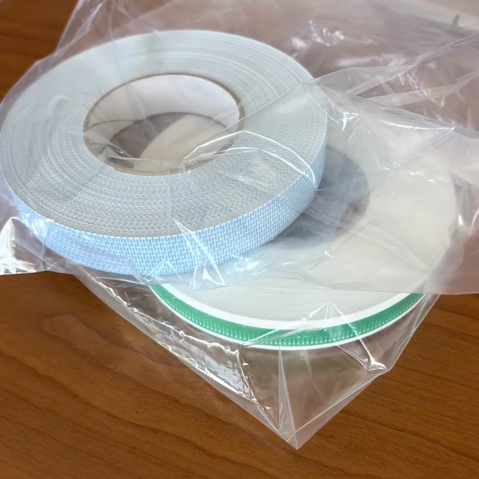 Bagged printed tape rolls on desk