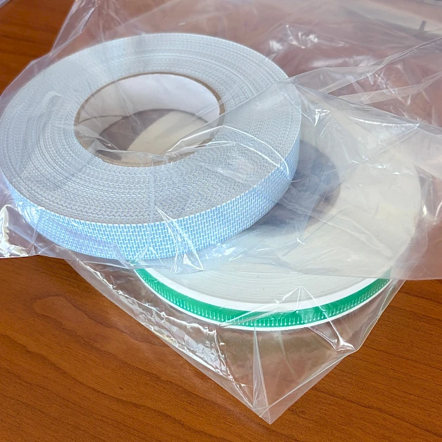 Bagged printed tape rolls on desk