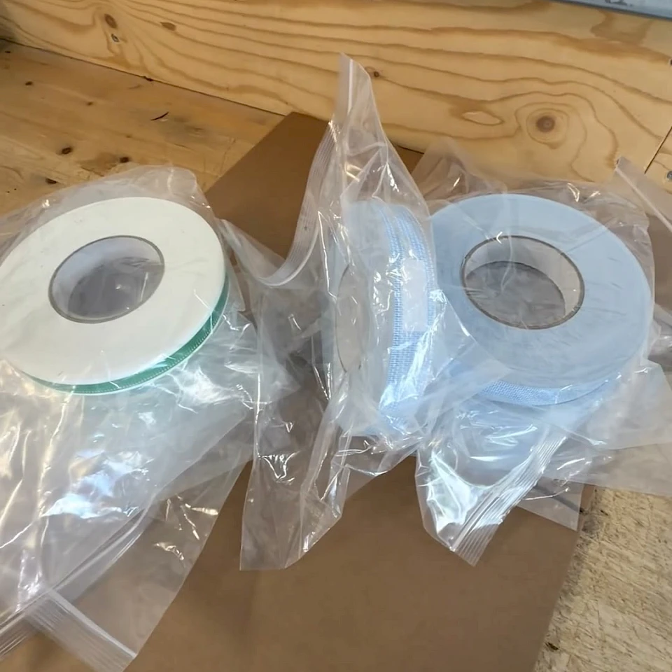 Bagged tape rolls on wooden bench