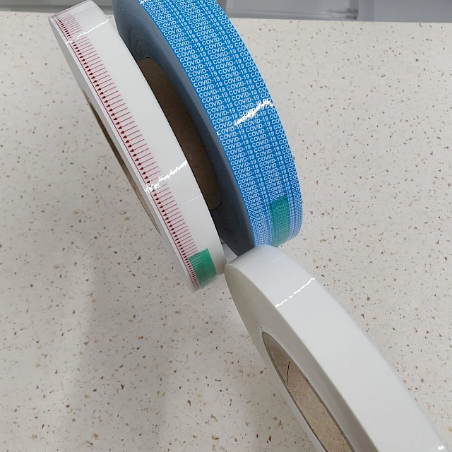 Blue and red printed tape rolls on countertop