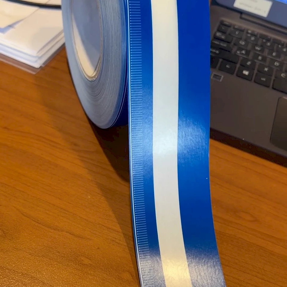 Blue and white scale tape roll with ruler