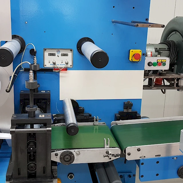Blue converting machine with conveyor and extraction fan