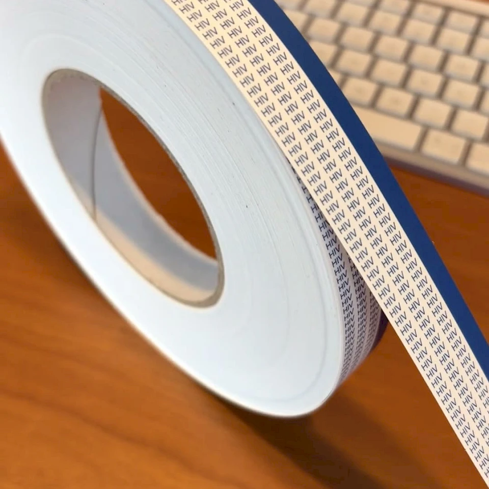 Blue edge printed tape roll by keyboard