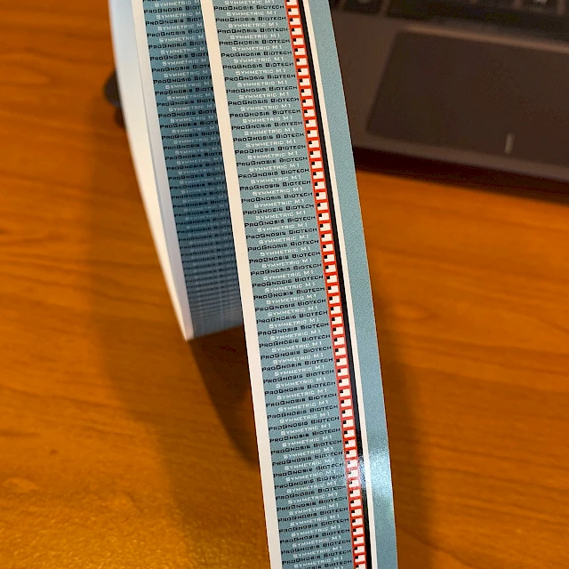 Blue grey printed tape roll standing on desk