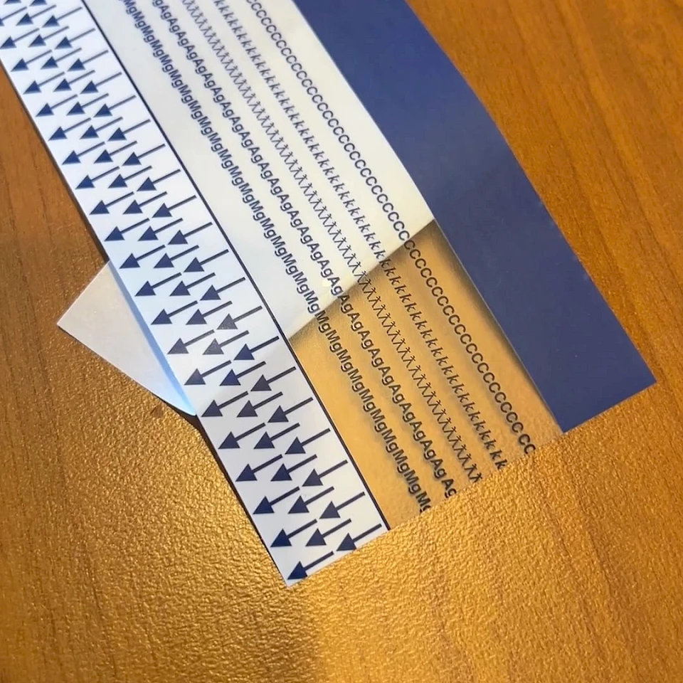 Blue printed arrow scale strip on desk