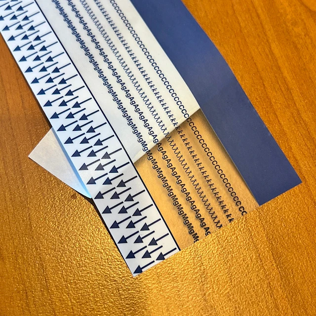 Blue printed arrow scale strip on desk