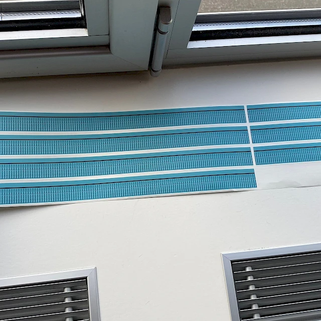 Blue printed strips on windowsill