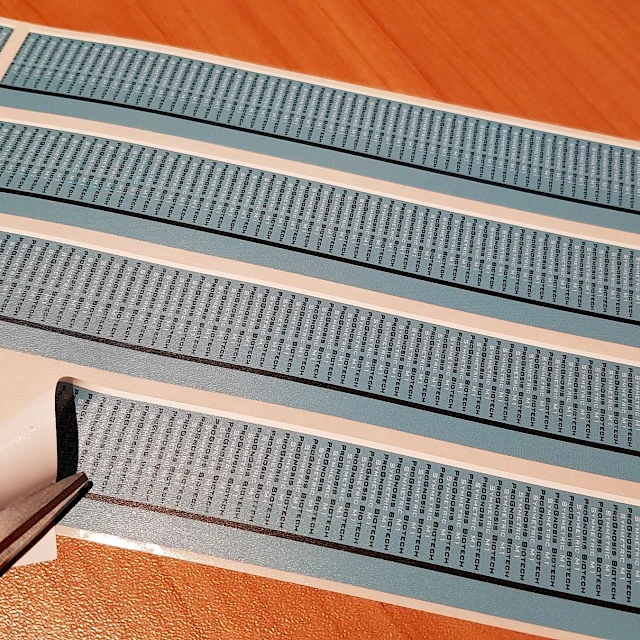 Blue printed strips peeled from liner