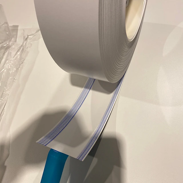 Blue printed tape roll unrolled strip
