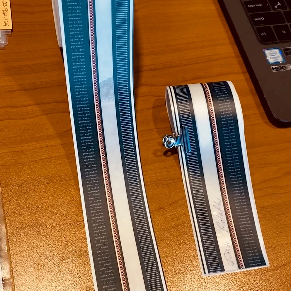 Blue printed tape strips on desk by laptop
