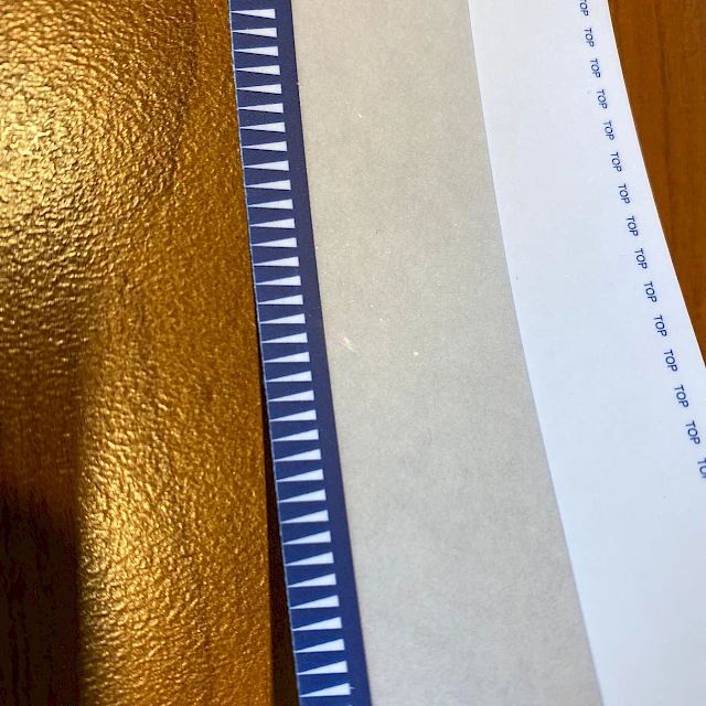 Blue sawtooth printed tape edge on wood