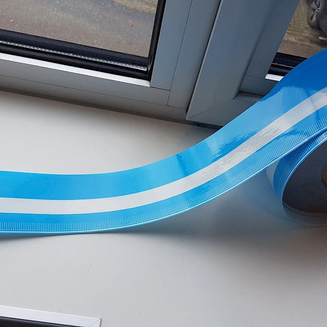 Blue striped cover tape roll on windowsill