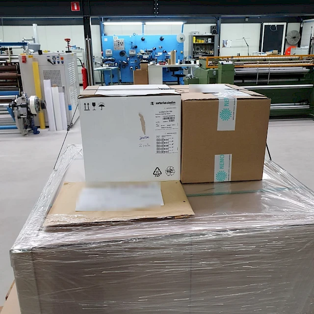Boxed shipment on pallet in factory hall