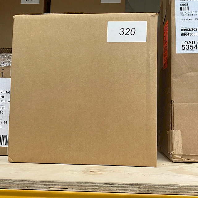 Carton marked 320 on warehouse shelf
