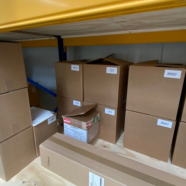 Cartons stacked on yellow pallet rack