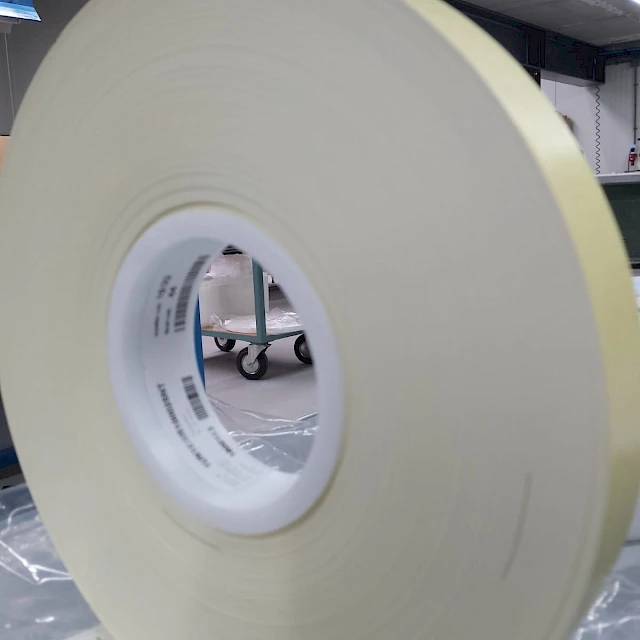 Cream adhesive tape roll on bag
