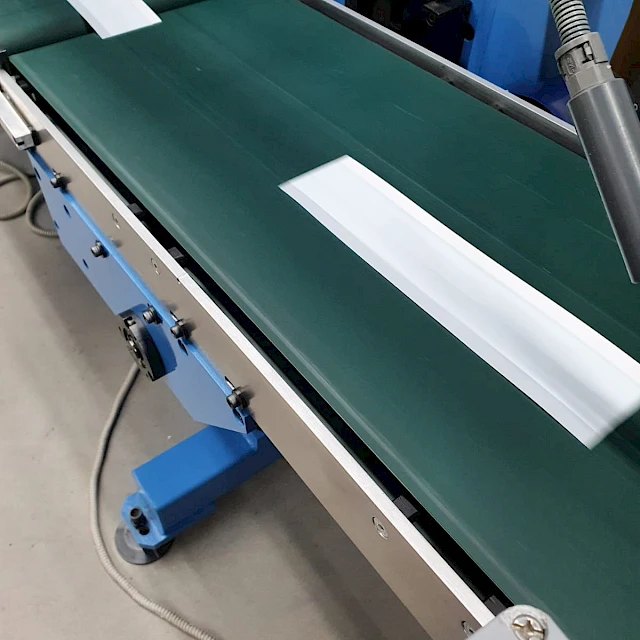 Cut cards on conveyor belt