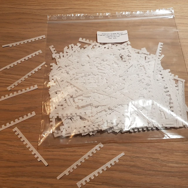 Die cut comb parts in bag