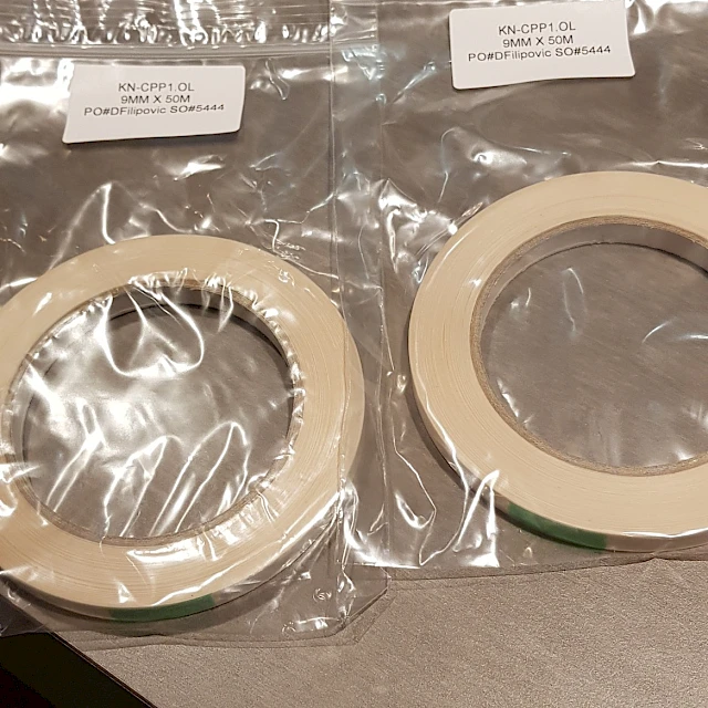 Double sided tape rolls in labelled zip bags