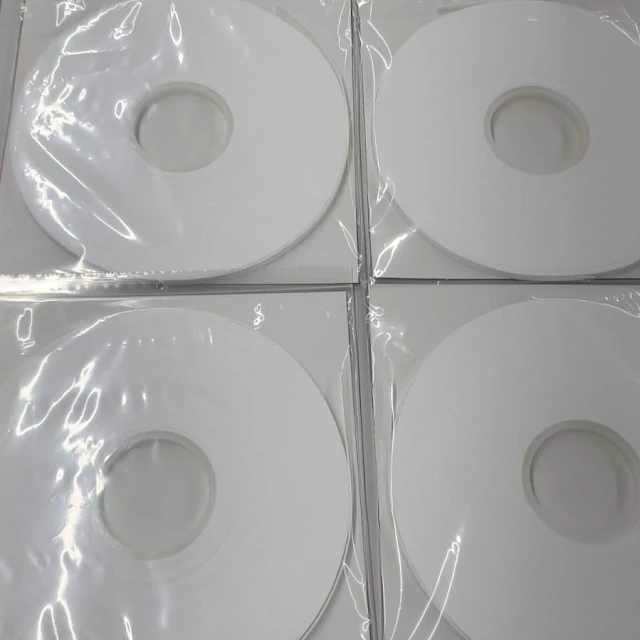 Four white pancake rolls in bags