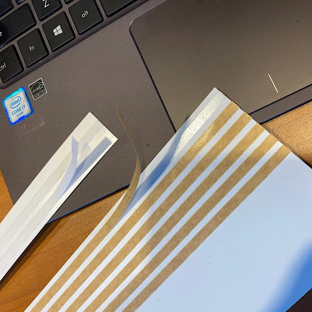 Gold striped laminate strips on laptop