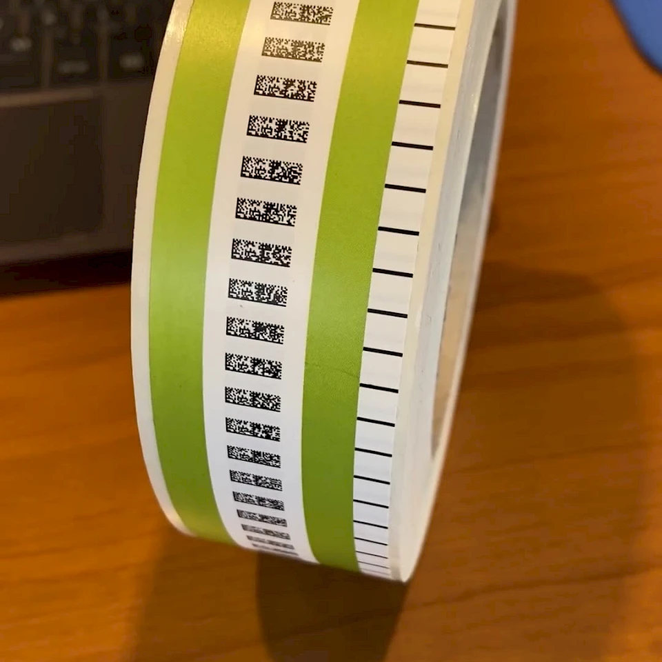 Green and white printed label roll on desk