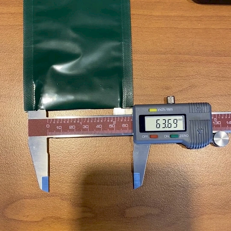 Green foil pouch measured with digital caliper