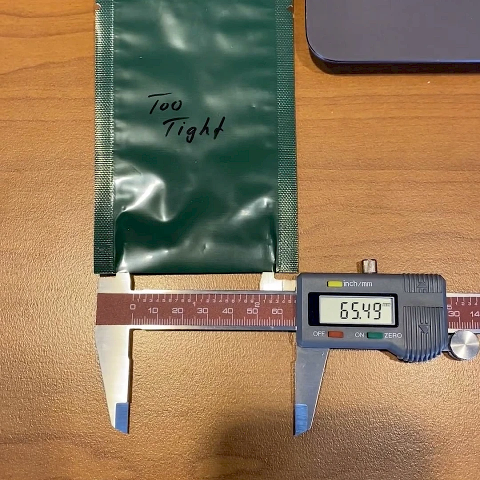 Green pouch marked too tight with caliper