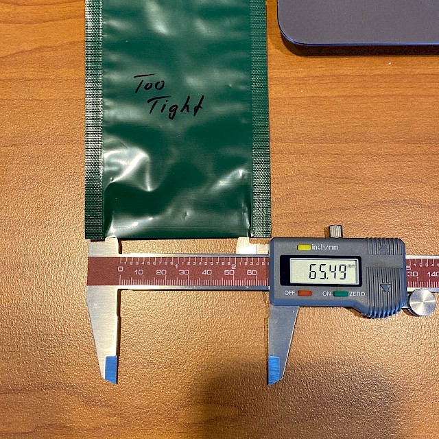 Green pouch marked too tight with caliper