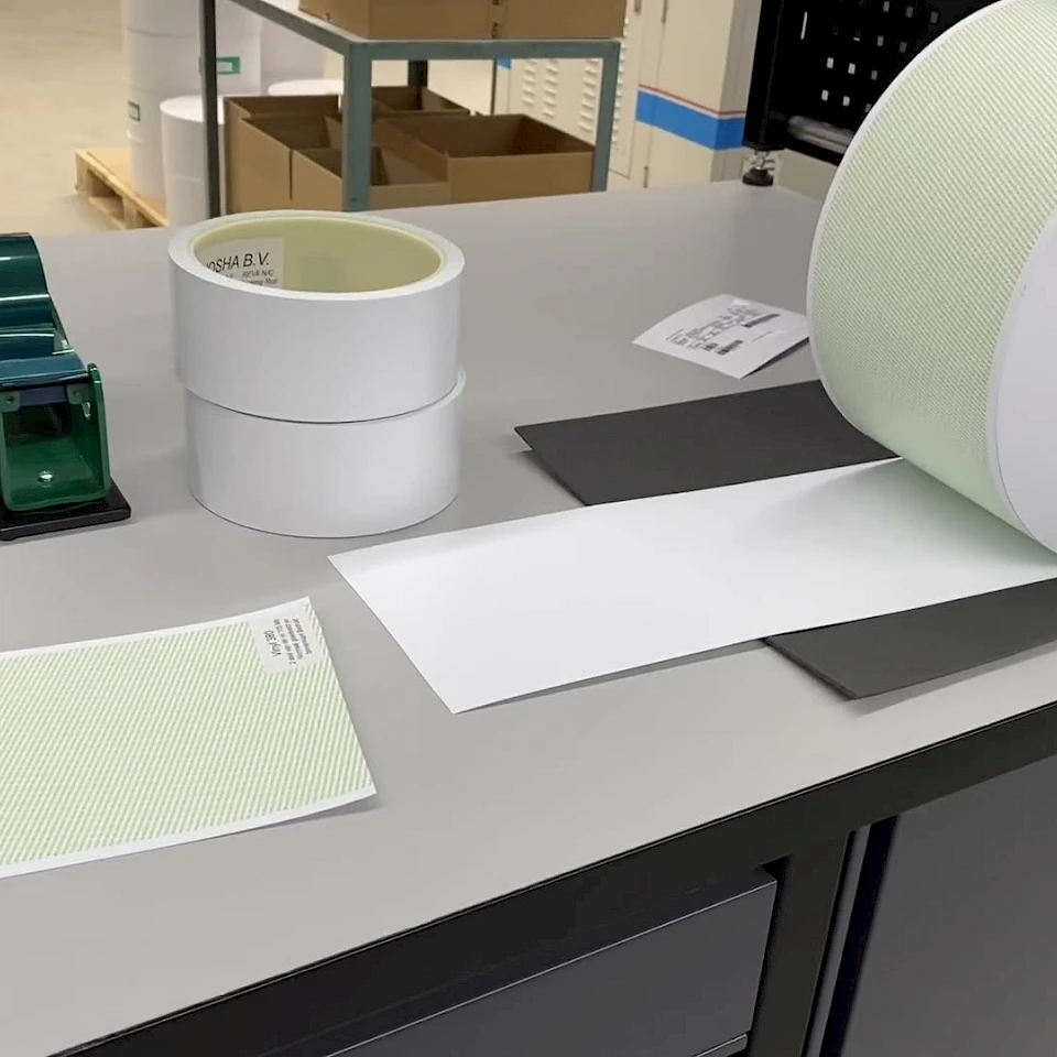 Green printed roll and tape dispensers on workbench