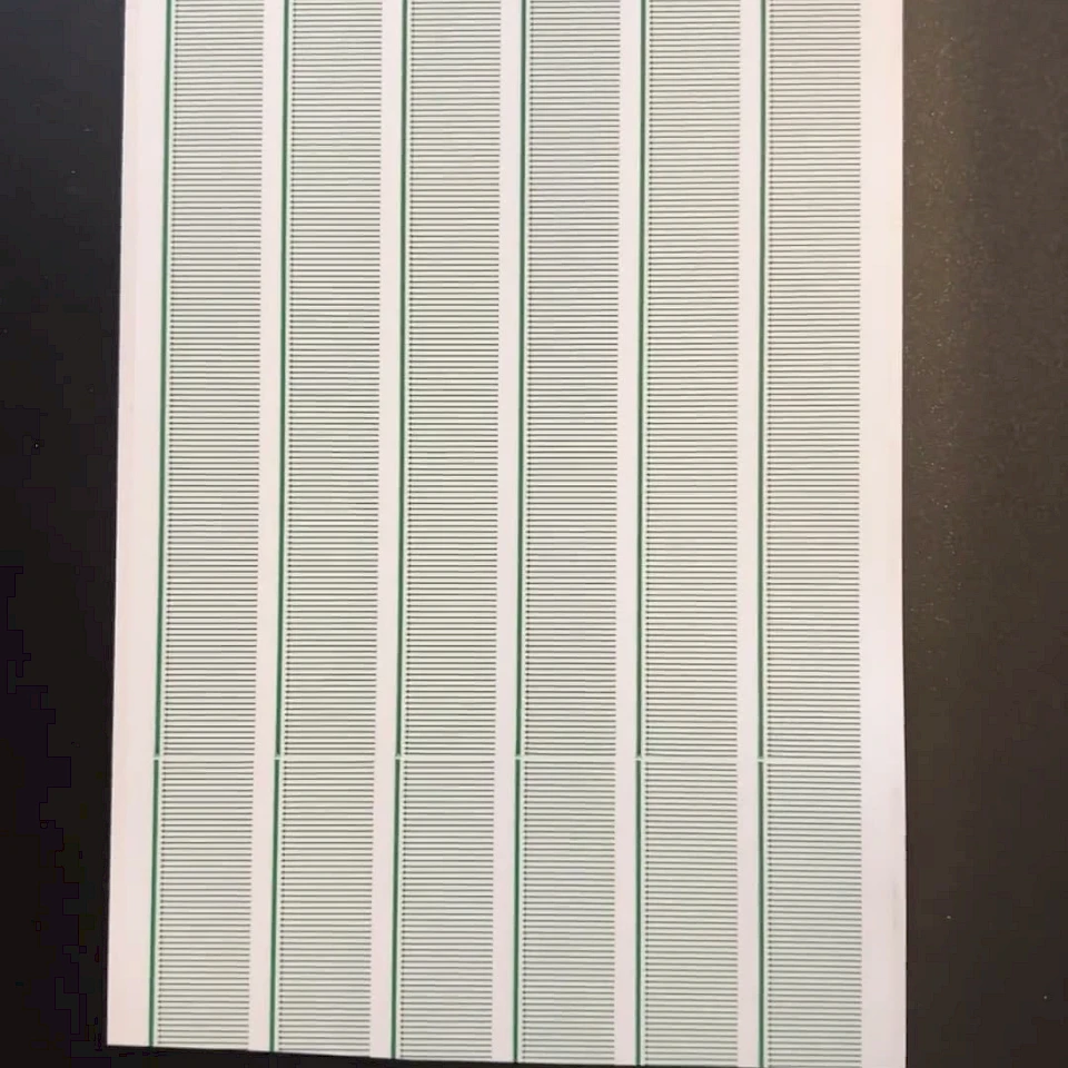 Green printed scale strip cards on black