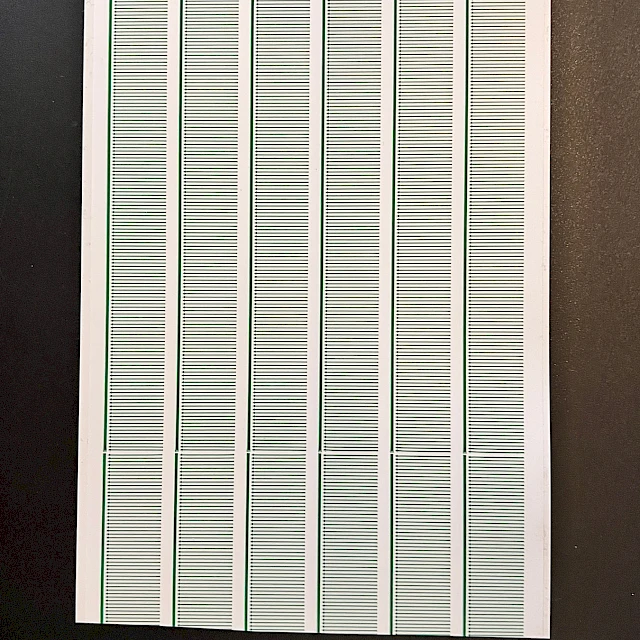 Green printed scale strip cards on black