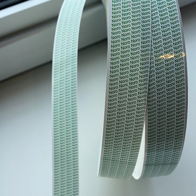 Green printed tape loop on windowsill