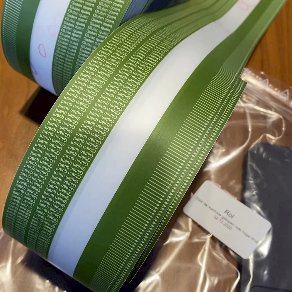 Green printed tape roll in bag