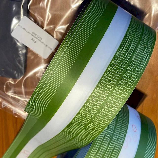 Green printed tape roll in bag