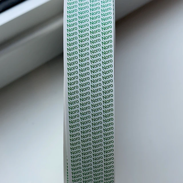 Green printed tape roll on windowsill