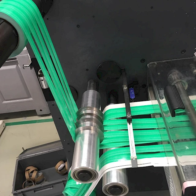 Green printed web on rotary die cutter