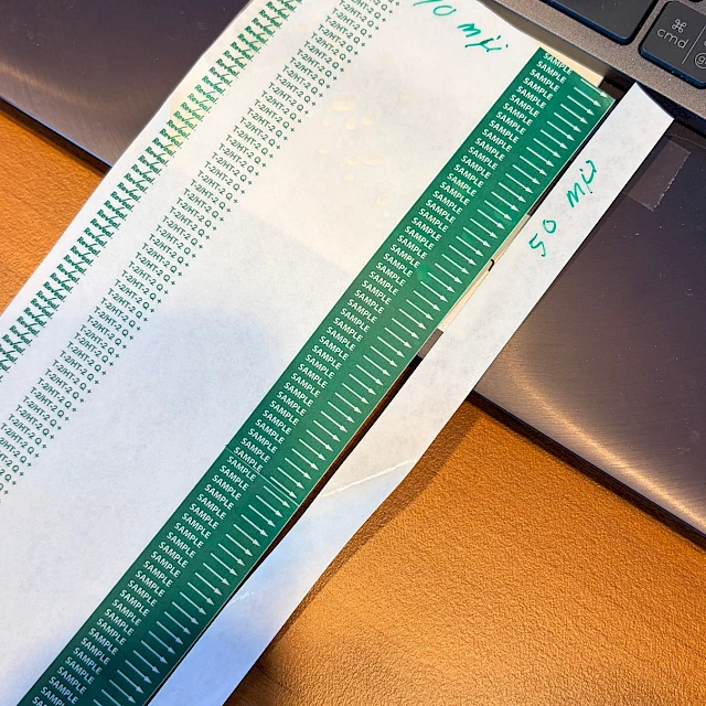 Green scale printed strips on laptop