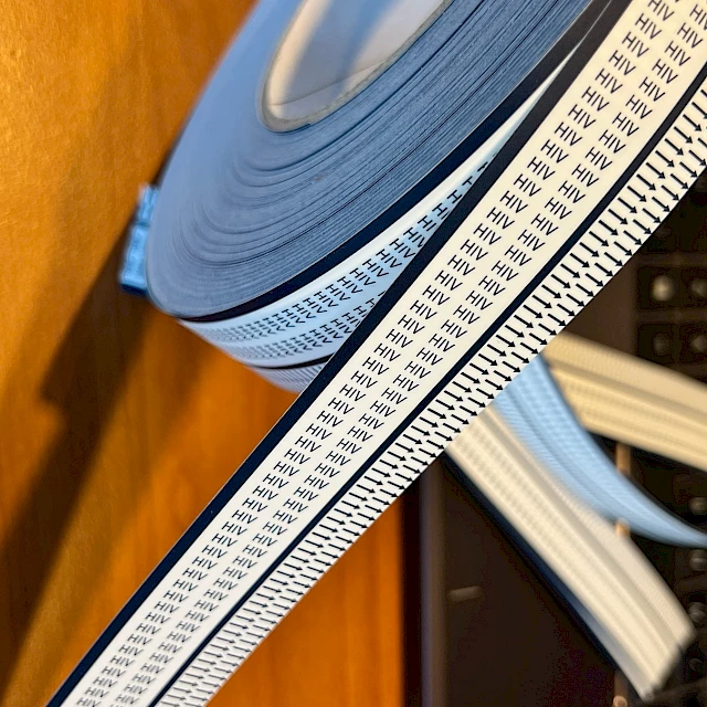 Hiv printed tape roll unwound by laptop