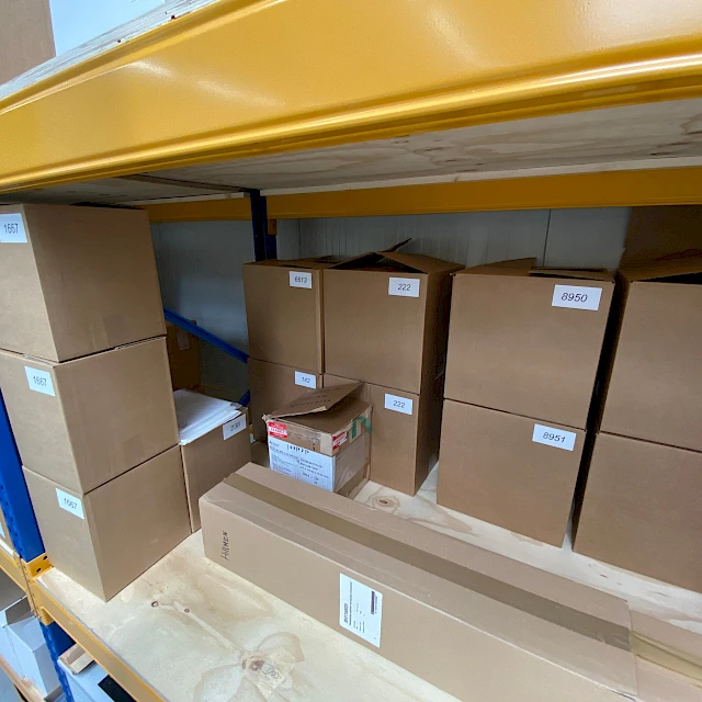 Labelled cartons on warehouse shelf