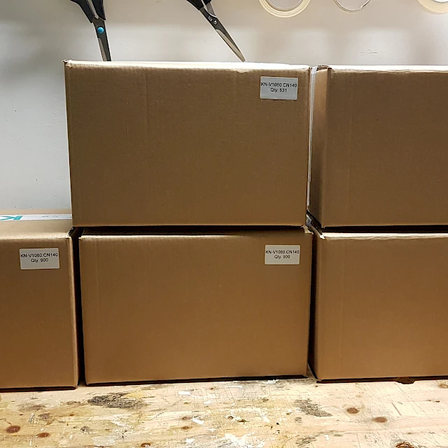 Labelled shipping cartons on workbench