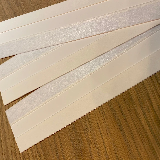 Laminated card strips angled close up