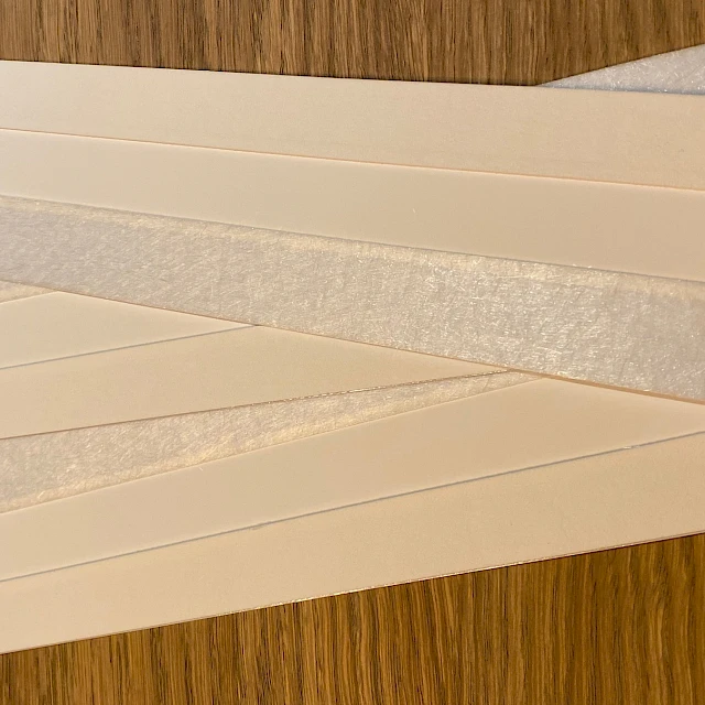 Laminated card strips fanned on table