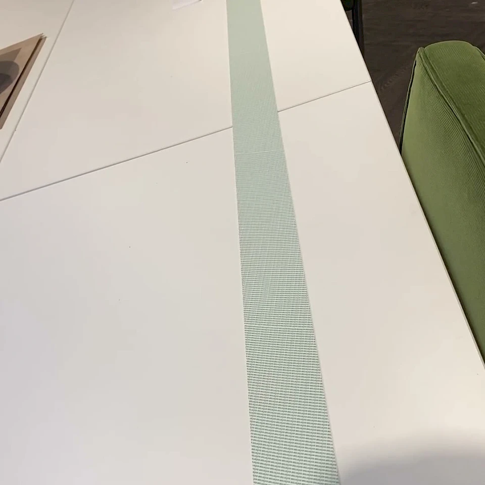 Long green printed tape strip on meeting table
