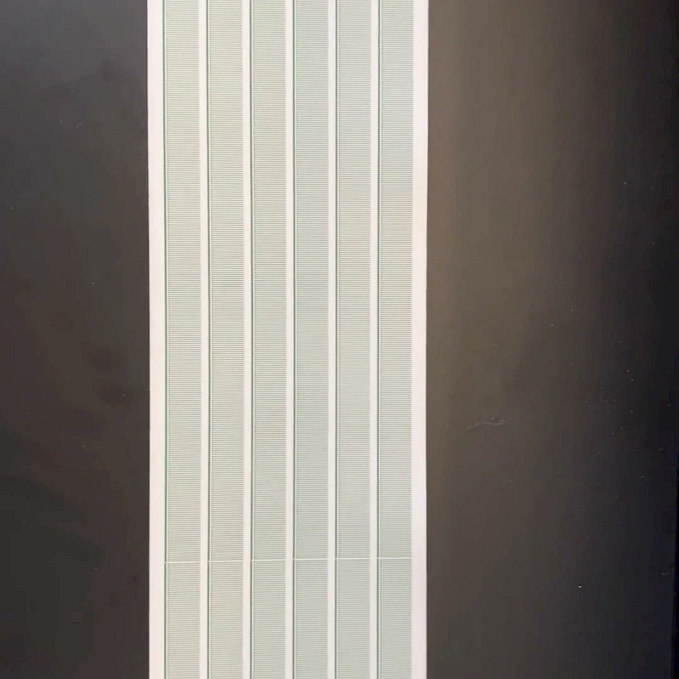 Long printed scale card on dark table