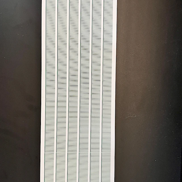 Long printed scale card on dark table