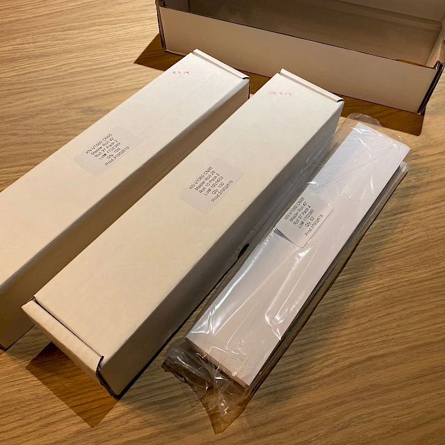 Long product boxes labelled on table