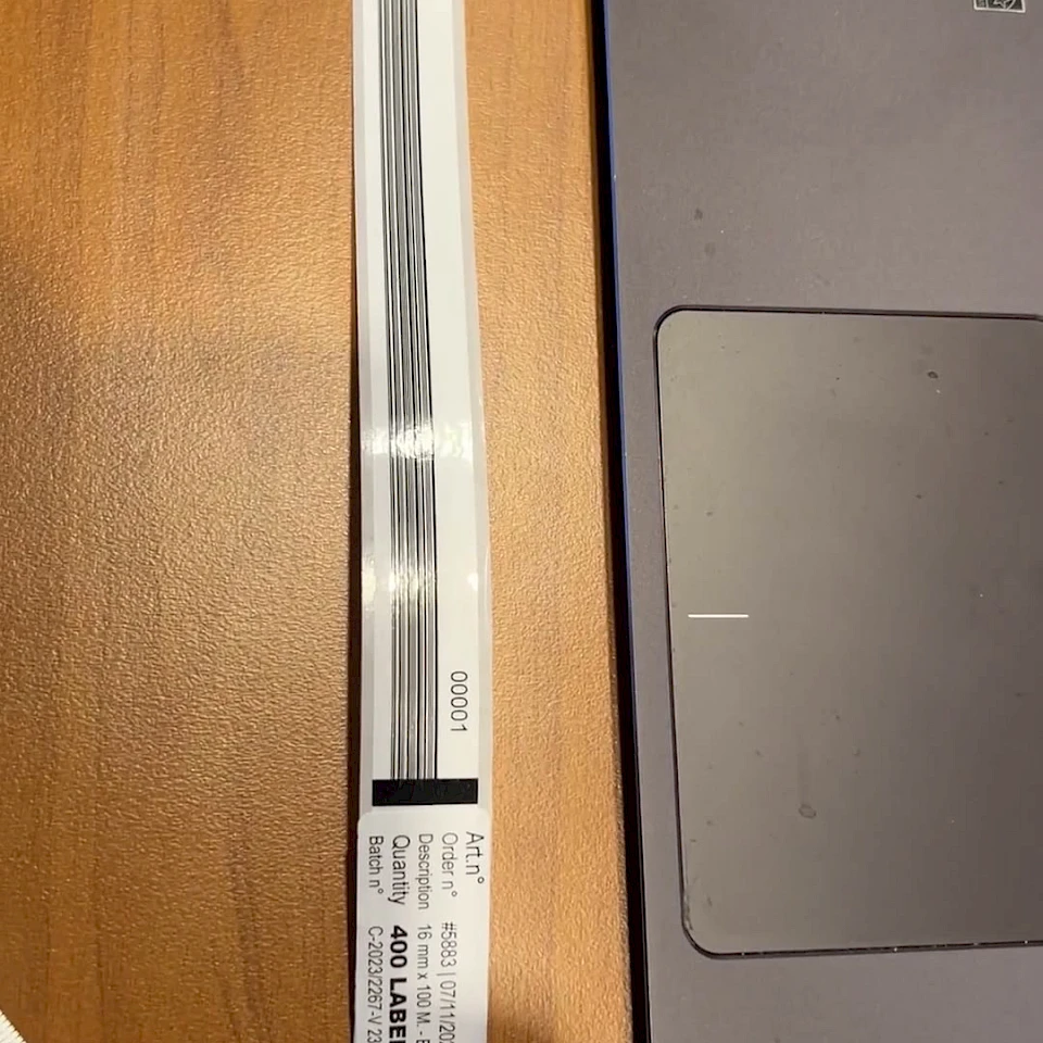 Narrow label strip roll on laptop