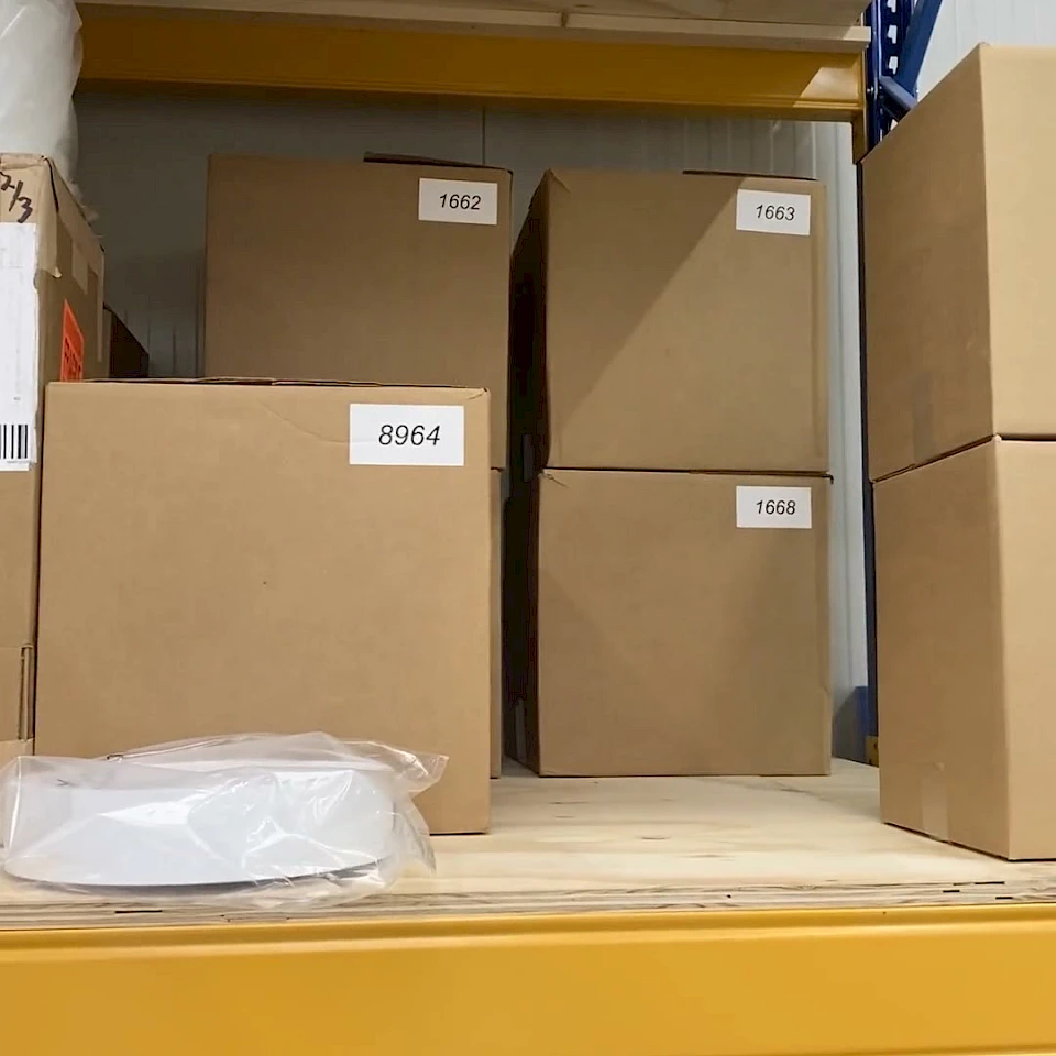 Numbered cartons and rolls on yellow rack shelf
