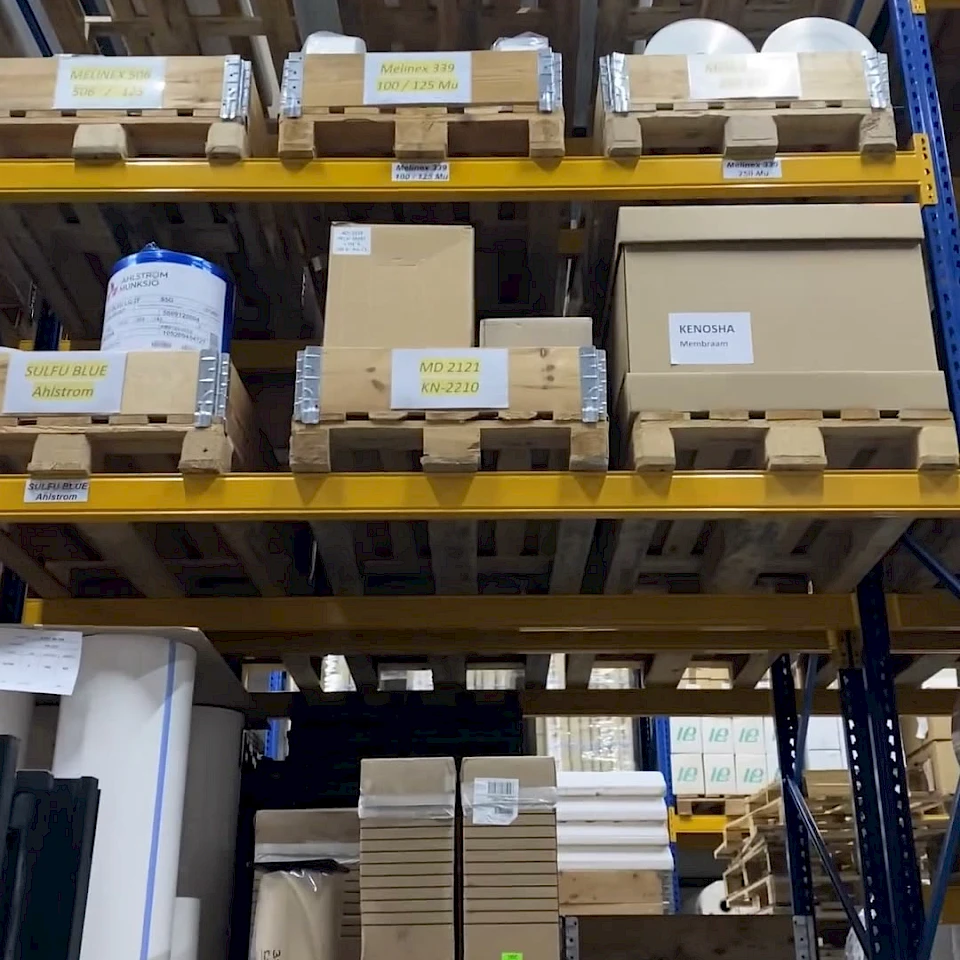 Pallet racking with labelled material rolls and boxes